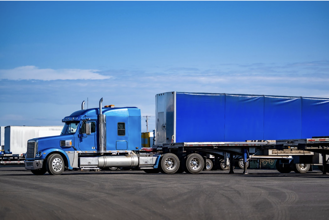 a trailer truck parked in a parking lot